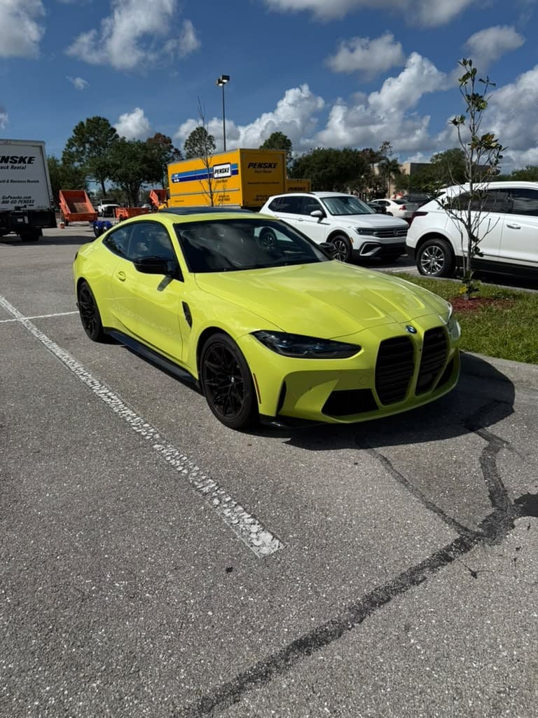 A BMW M4 finished with Formula 1051, the coated paint holding a mirror finish in daylight