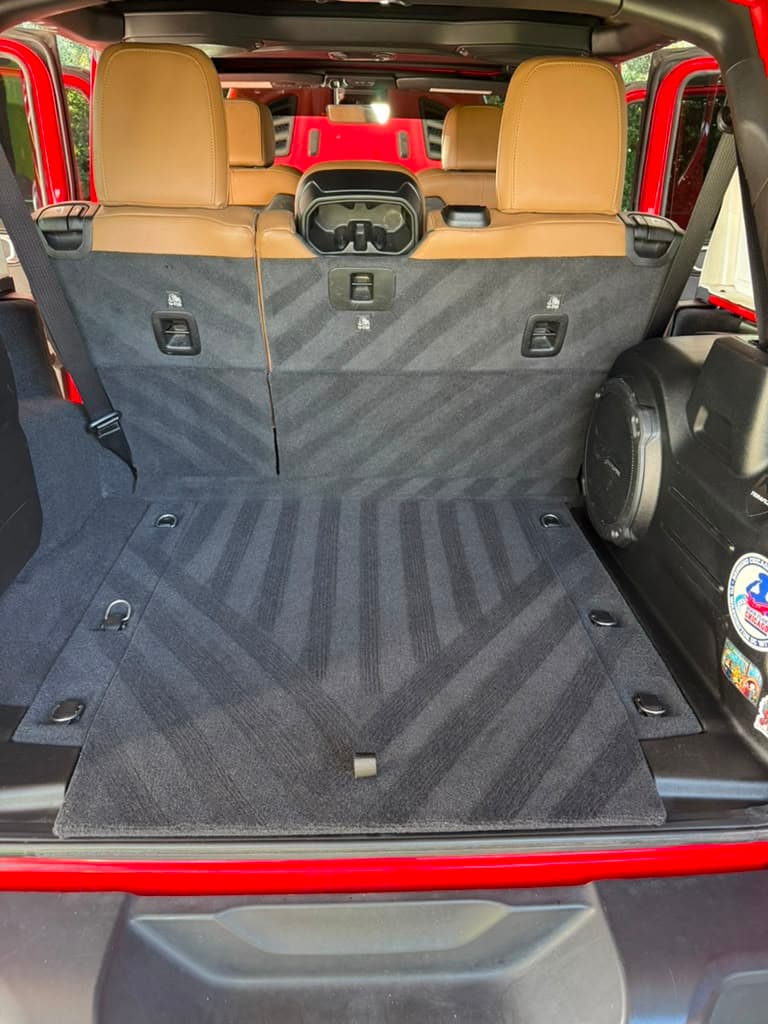 Cargo area of an SUV after a full interior detail, carpet vacuumed to clean lines
